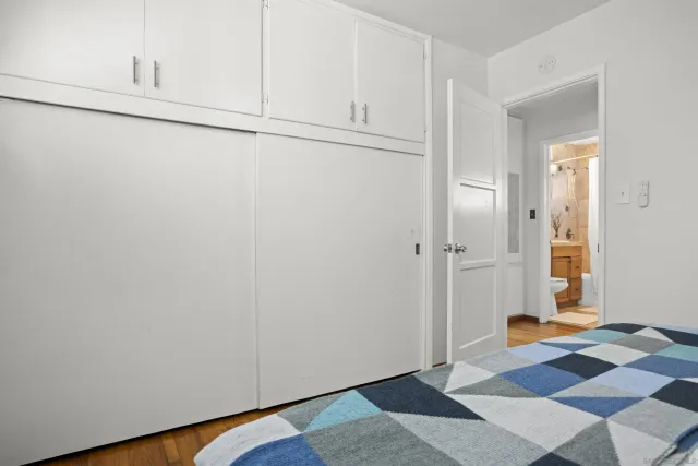 a view of a room with wooden floor and cabinet