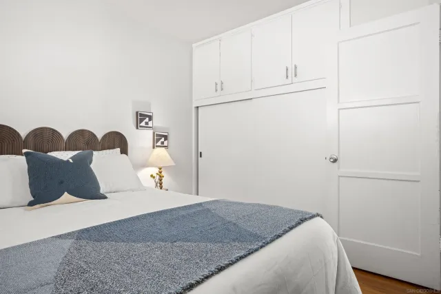 a bedroom with a bed and cabinet