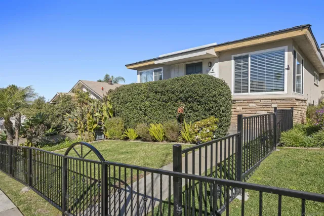 a view of a house with wooden fence