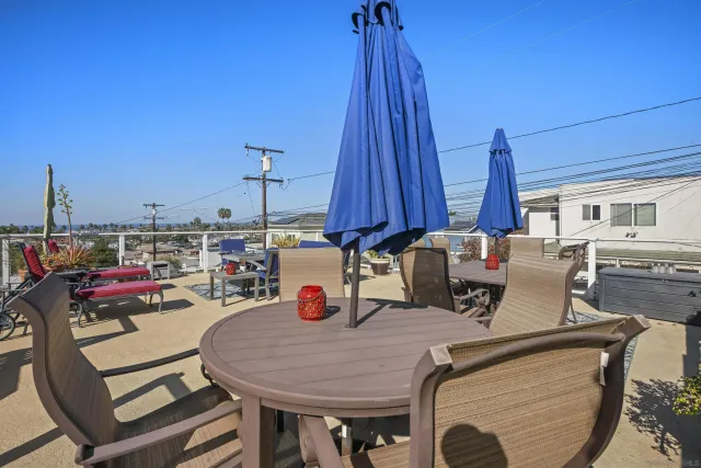 a view of a dining room with furniture and a chandelier