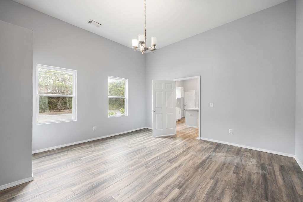 2113 Summerville Road Phenix City, AL 36867 - Photo 19 of 37 a view of an empty room with wooden floor and a window