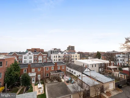 a view of a terrace with furniture and umbrella