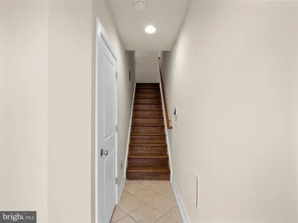 a view of a hallway with wooden floor and entryway