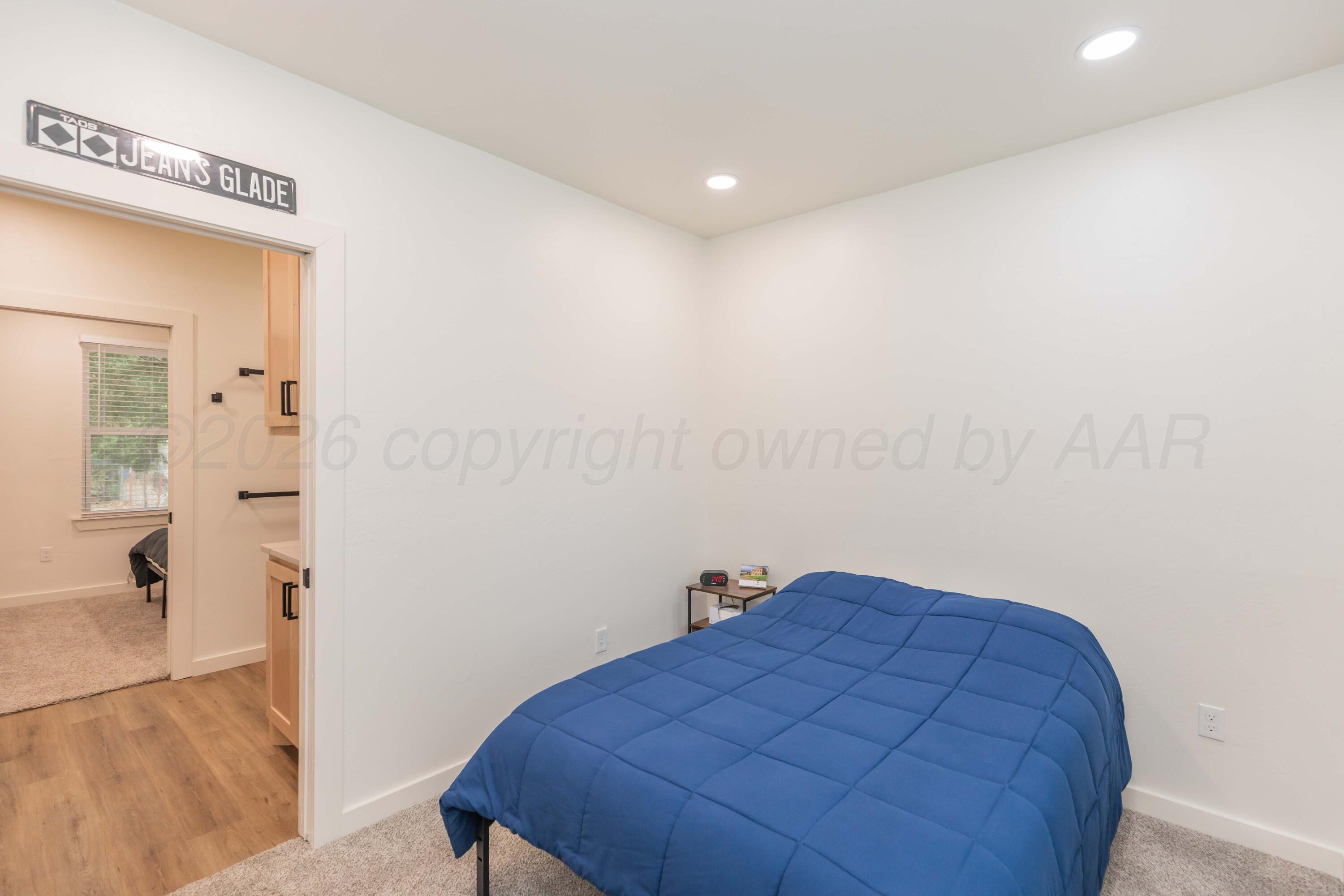504 High Street Claude, TX 79019 - Photo 10 of 39 a bedroom with a bed and a mirror
