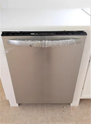 an empty room with wooden floor closet and windows