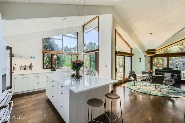 a kitchen with counter top space and living room