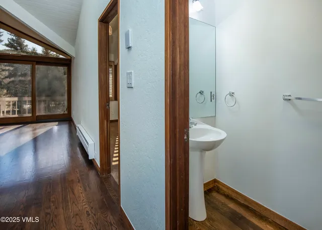 a spacious bedroom with a bed and a flat screen tv