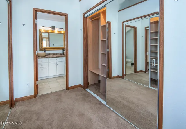 a bedroom with bed and a large mirror