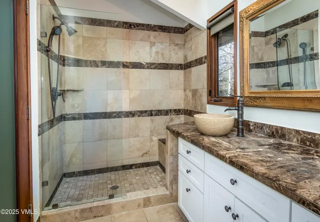 a bathroom with a toilet sink and a mirror