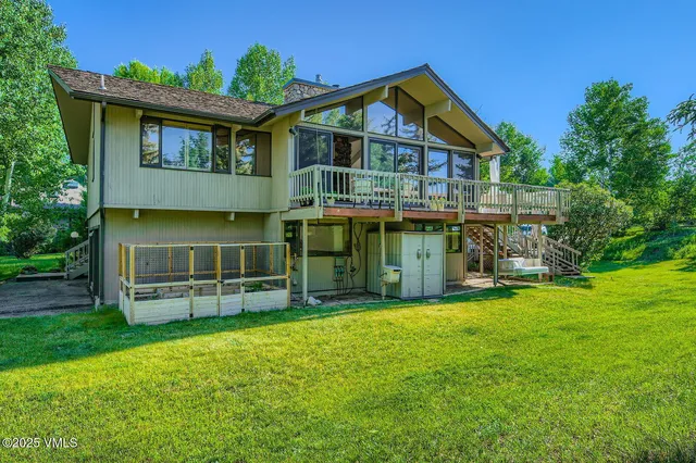 a front view of a house with yard and trees