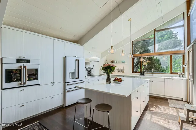 a utility room with sink a stove and a window