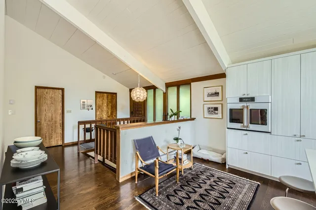 a living room with fireplace furniture and a large window