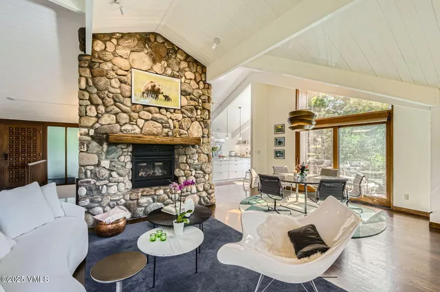 a living room with furniture and floor to ceiling windows