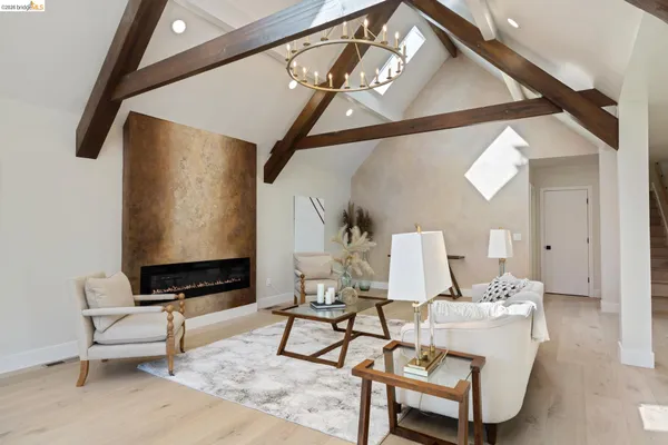 a living room with furniture and a painting on the wall