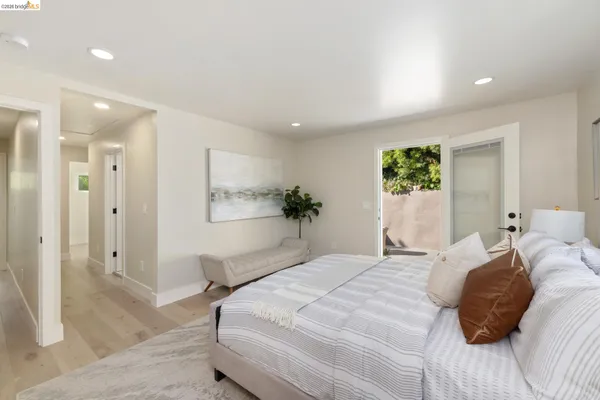 a bedroom with a bed and a painting on the wall