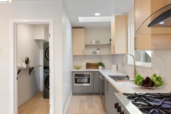 a kitchen with kitchen island white cabinets and a stove