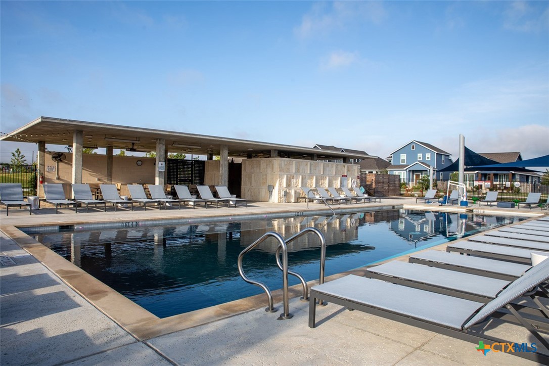 6313 McMurtry Street Austin, TX 78747 - Photo 3 of 12 a view of a swimming pool with outdoor seating