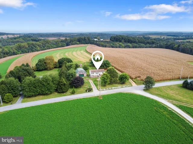 an aerial view of a house with yard and outdoor seating
