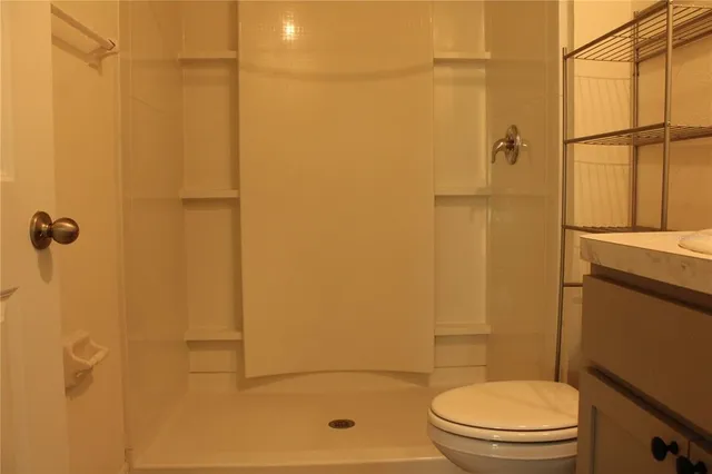 a bathroom with a toilet and shower