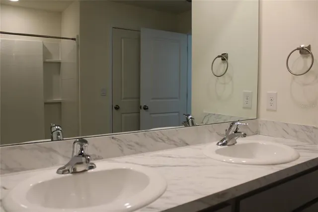 a bathroom with a glass shower door