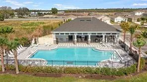 an aerial view of residential houses with outdoor space and river