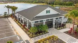 a aerial view of a house with a yard patio and lake view