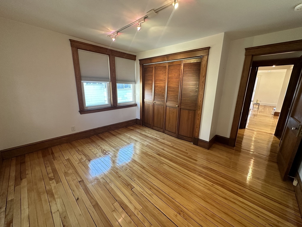 17 Herbert Road, Unit 1 Arlington, MA 02474 - Photo 14 of 26 an empty room with wooden floor and windows