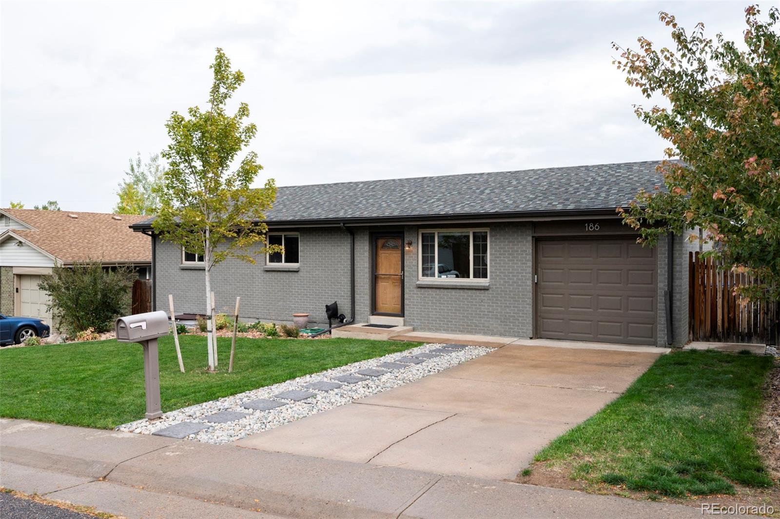 186 Quaker Street Golden, CO 80401 - Photo 1 of 50 a front view of a house with a yard garage and outdoor seating
