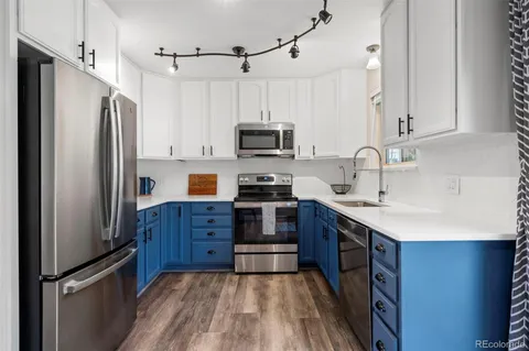 a kitchen with stainless steel appliances a refrigerator stove and sink