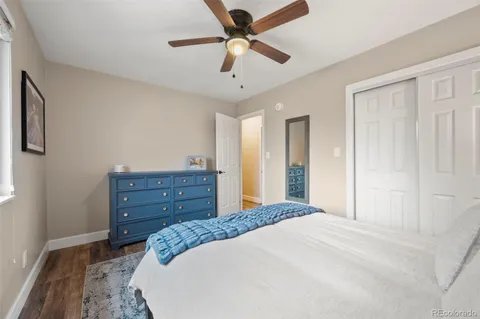 a bed room with a bed and a ceiling fan