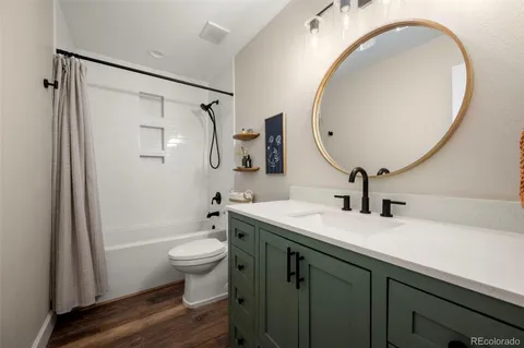 a bathroom with a sink a toilet and a mirror