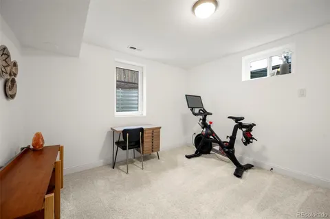a room with gym equipment and a window