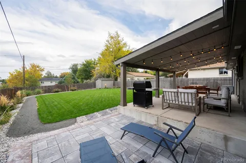 a view of a patio with a yard