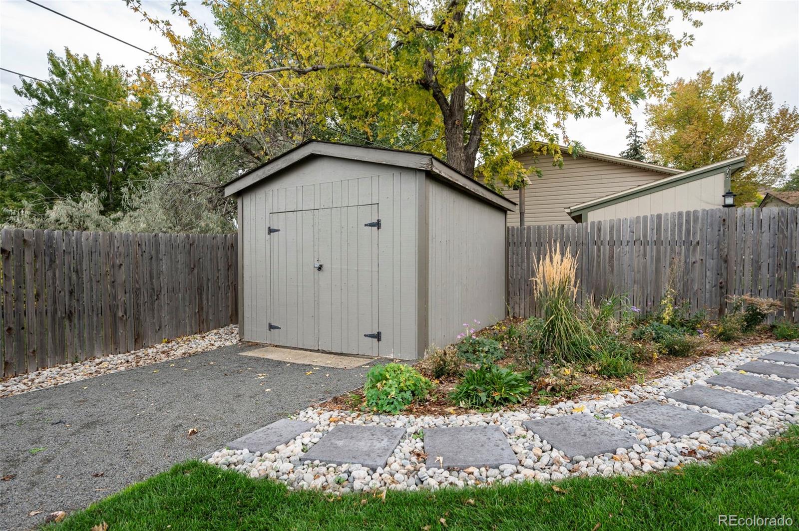 186 Quaker Street Golden, CO 80401 - Photo 46 of 50 a backyard of a house with plants and trees with wooden fence