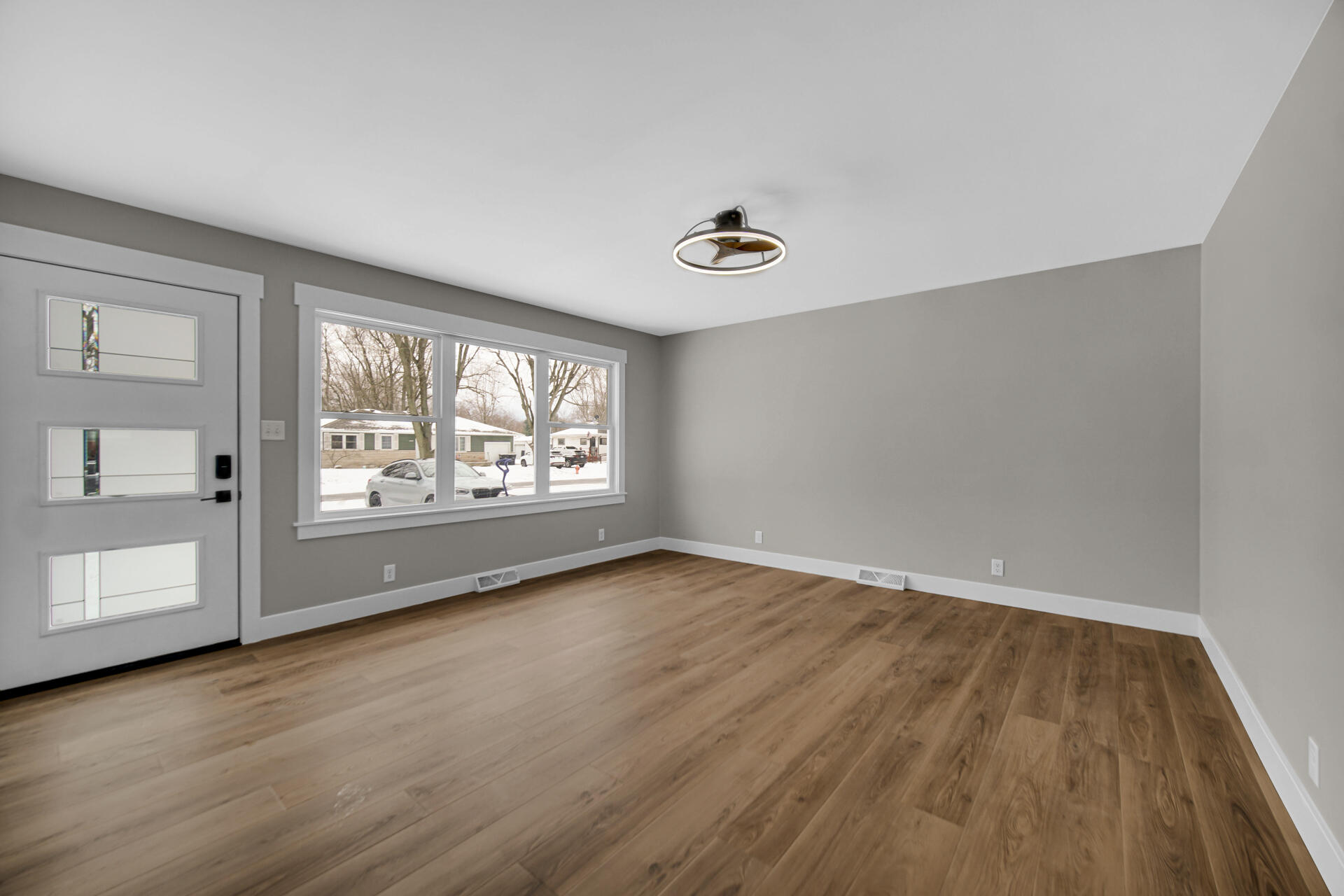 2792 Irving Street Portage, IN 46368 - Photo 4 of 16 an empty room with wooden floor and windows