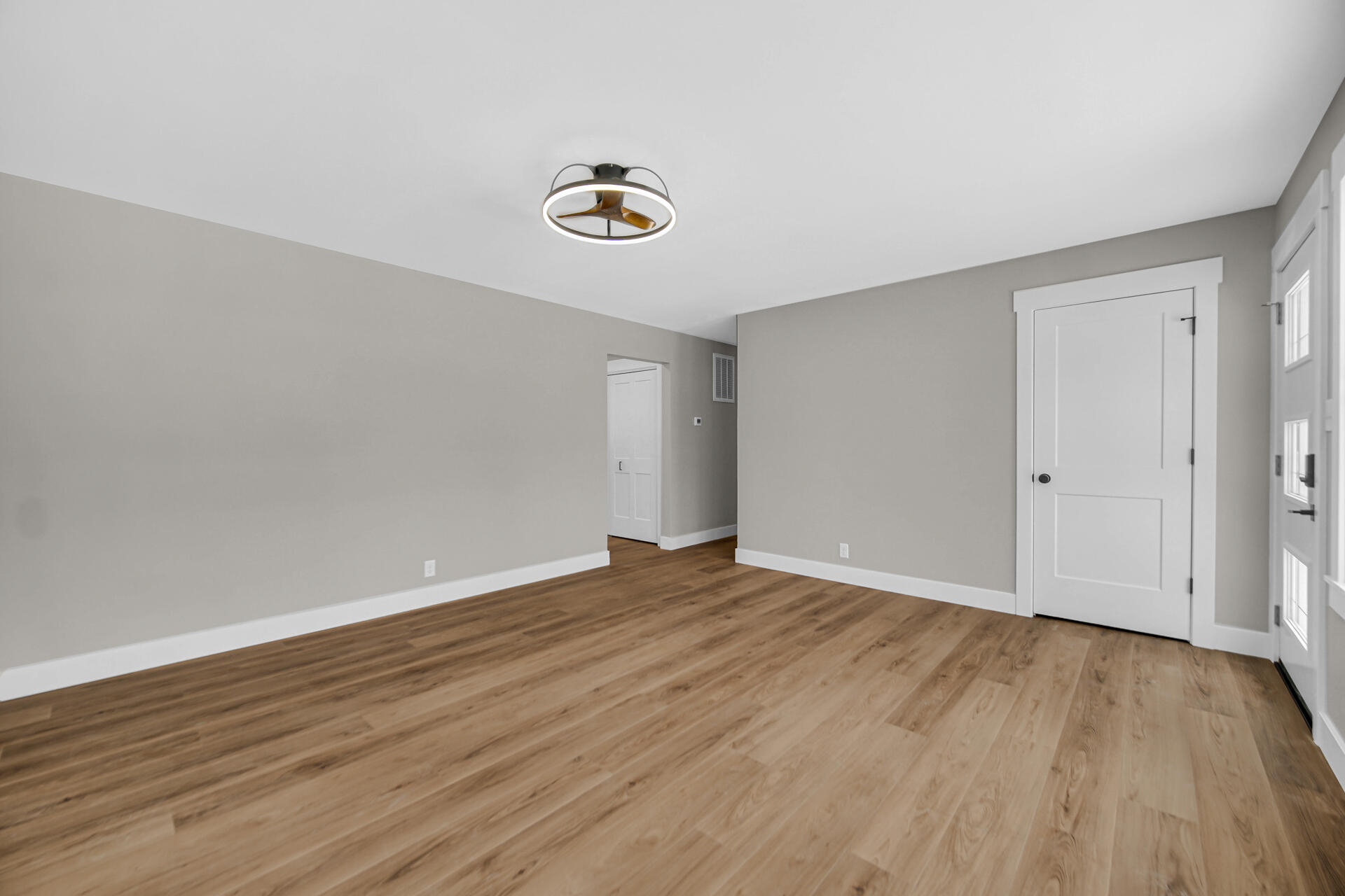 2792 Irving Street Portage, IN 46368 - Photo 6 of 16 a view of an empty room with wooden floor and a window