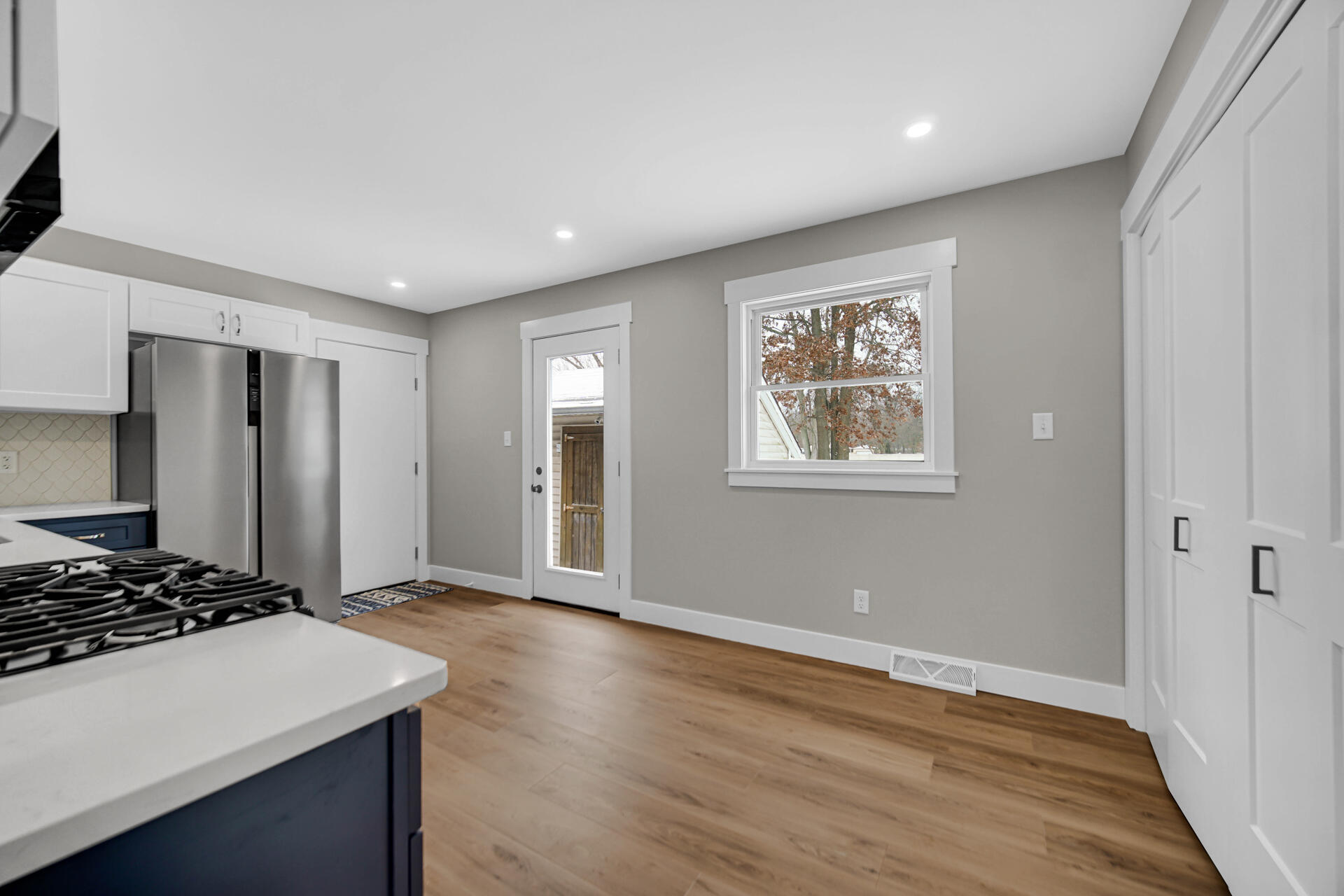 2792 Irving Street Portage, IN 46368 - Photo 9 of 16 a view of an empty room with wooden floor and a window