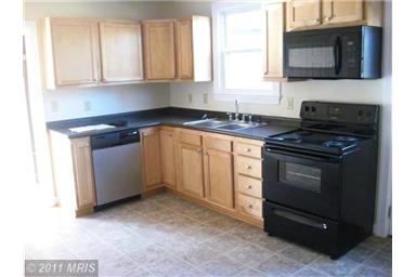 1130 George James Loop Radiant, VA 22732 - Photo 5 of 10 a kitchen with granite countertop a stove top oven microwave and cabinets