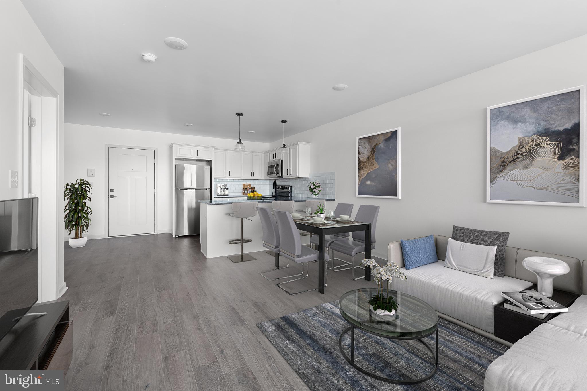 a living room with furniture and kitchen view