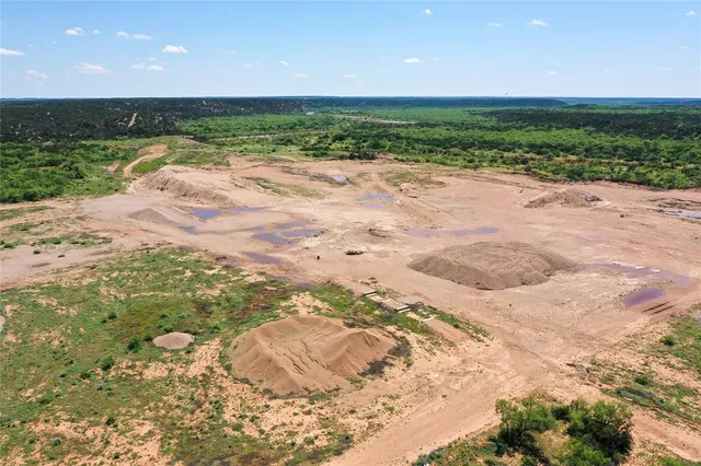 a view of a lake with beach and outdoor space