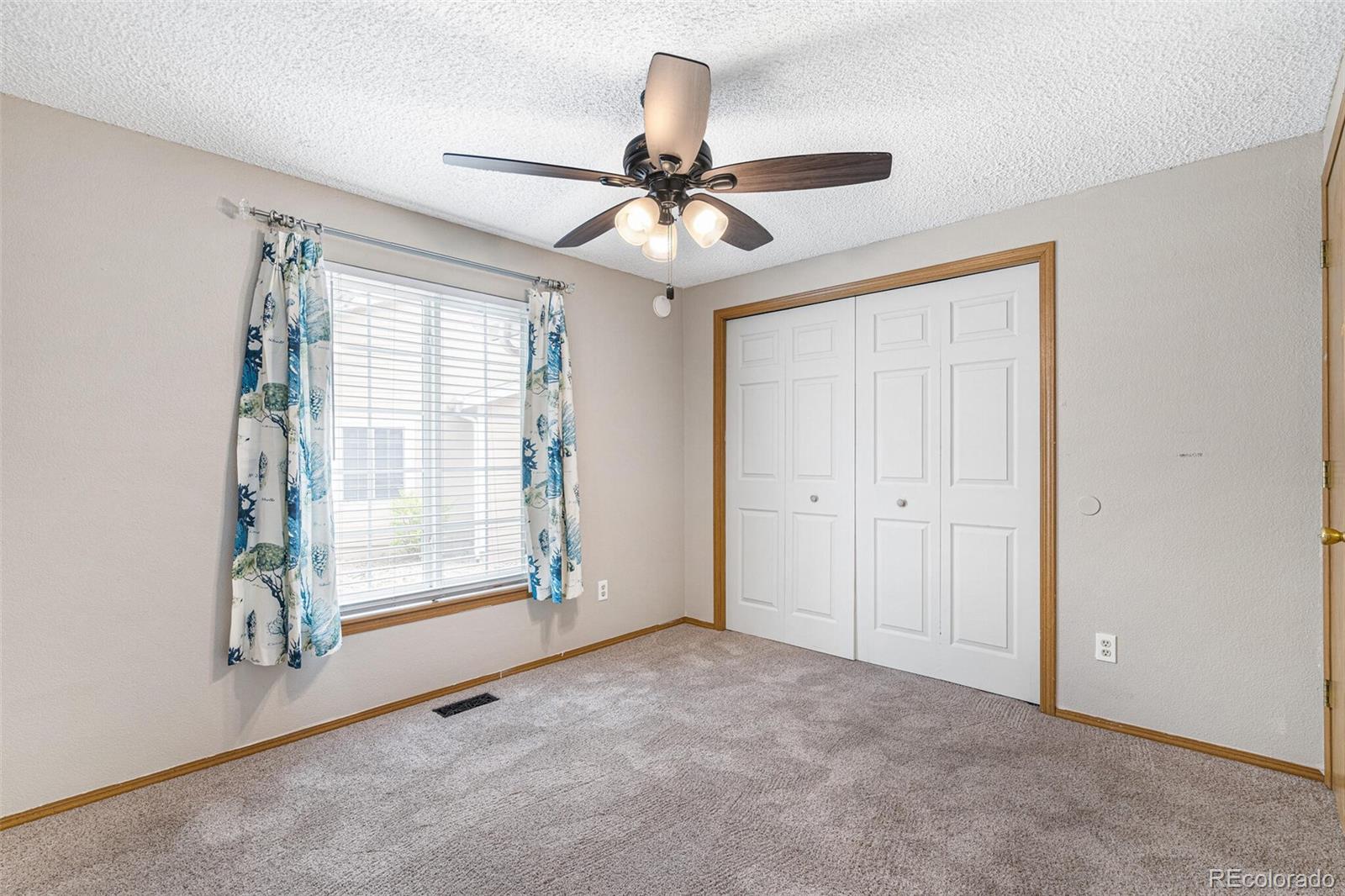 8424 Everett Way, Unit A Arvada, CO 80005 - Photo 16 of 25 a view of an empty room with a window