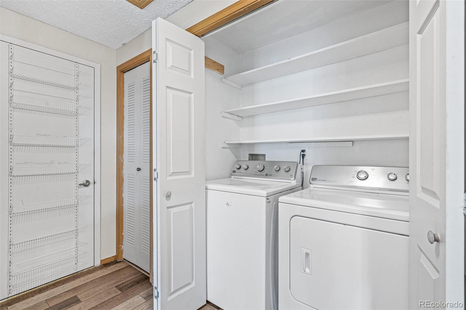 8424 Everett Way, Unit A Arvada, CO 80005 - Photo 18 of 25 a view of storage and utility room with washer and dryer