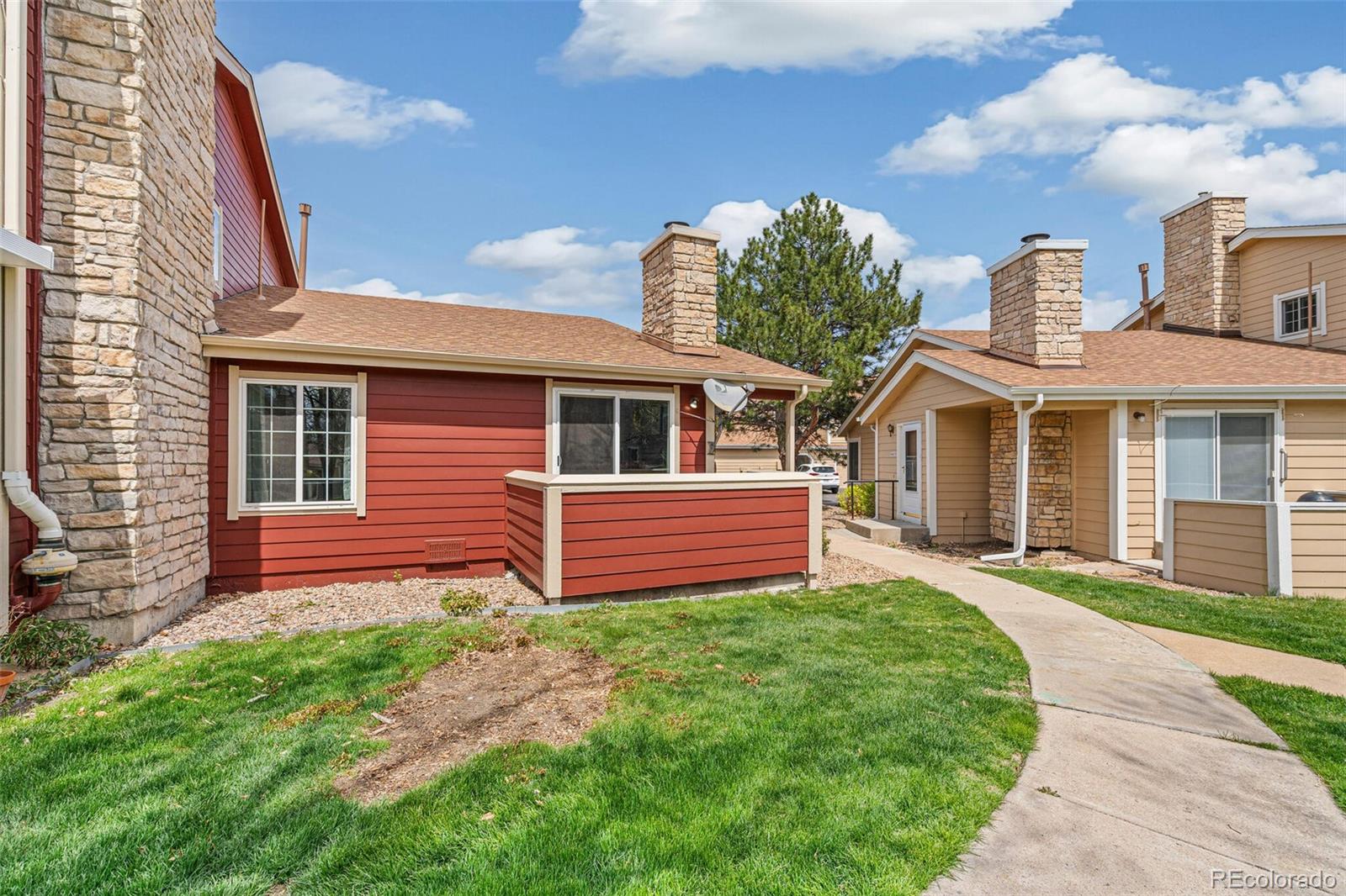 8424 Everett Way, Unit A Arvada, CO 80005 - Photo 20 of 25 a front view of a house with a yard