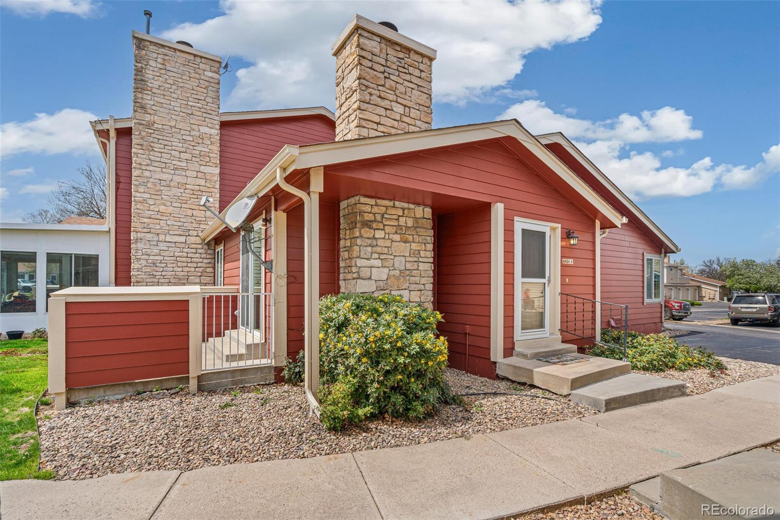 8424 Everett Way, Unit A Arvada, CO 80005 - Photo 2 of 25 a front view of a house with garden