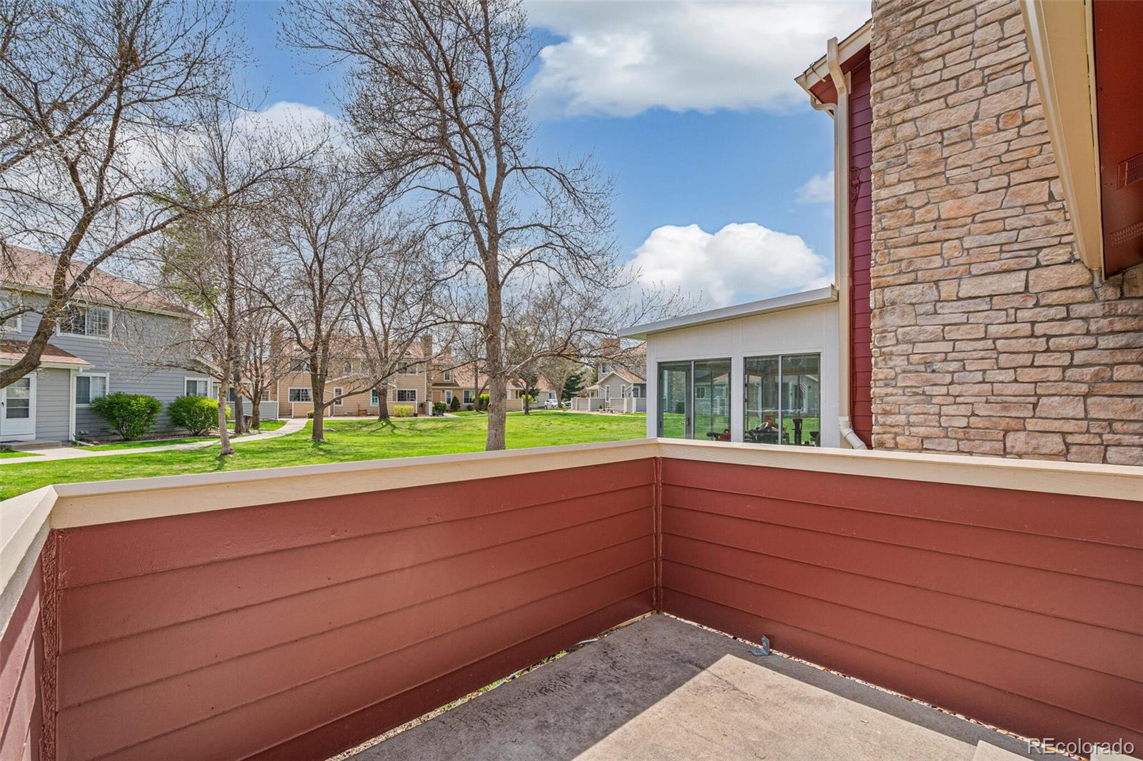 8424 Everett Way, Unit A Arvada, CO 80005 - Photo 22 of 25 a view of a house with a backyard and a tree