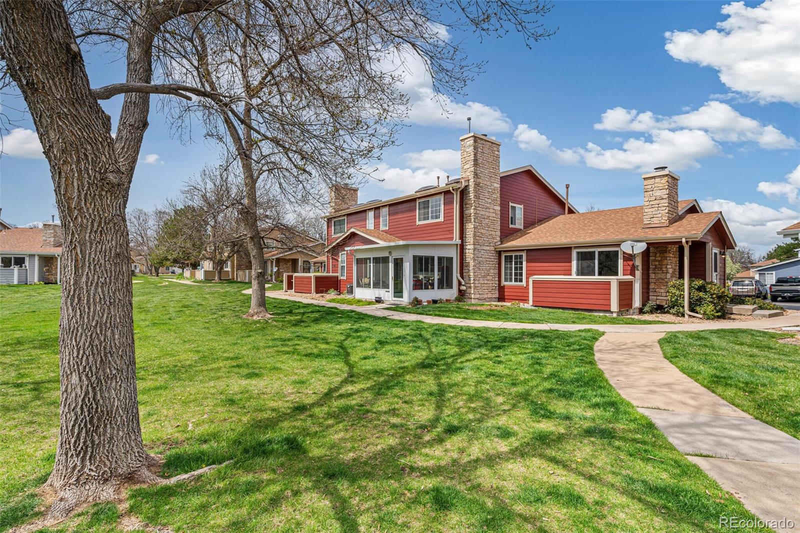 8424 Everett Way, Unit A Arvada, CO 80005 - Photo 3 of 25 a front view of a house with garden