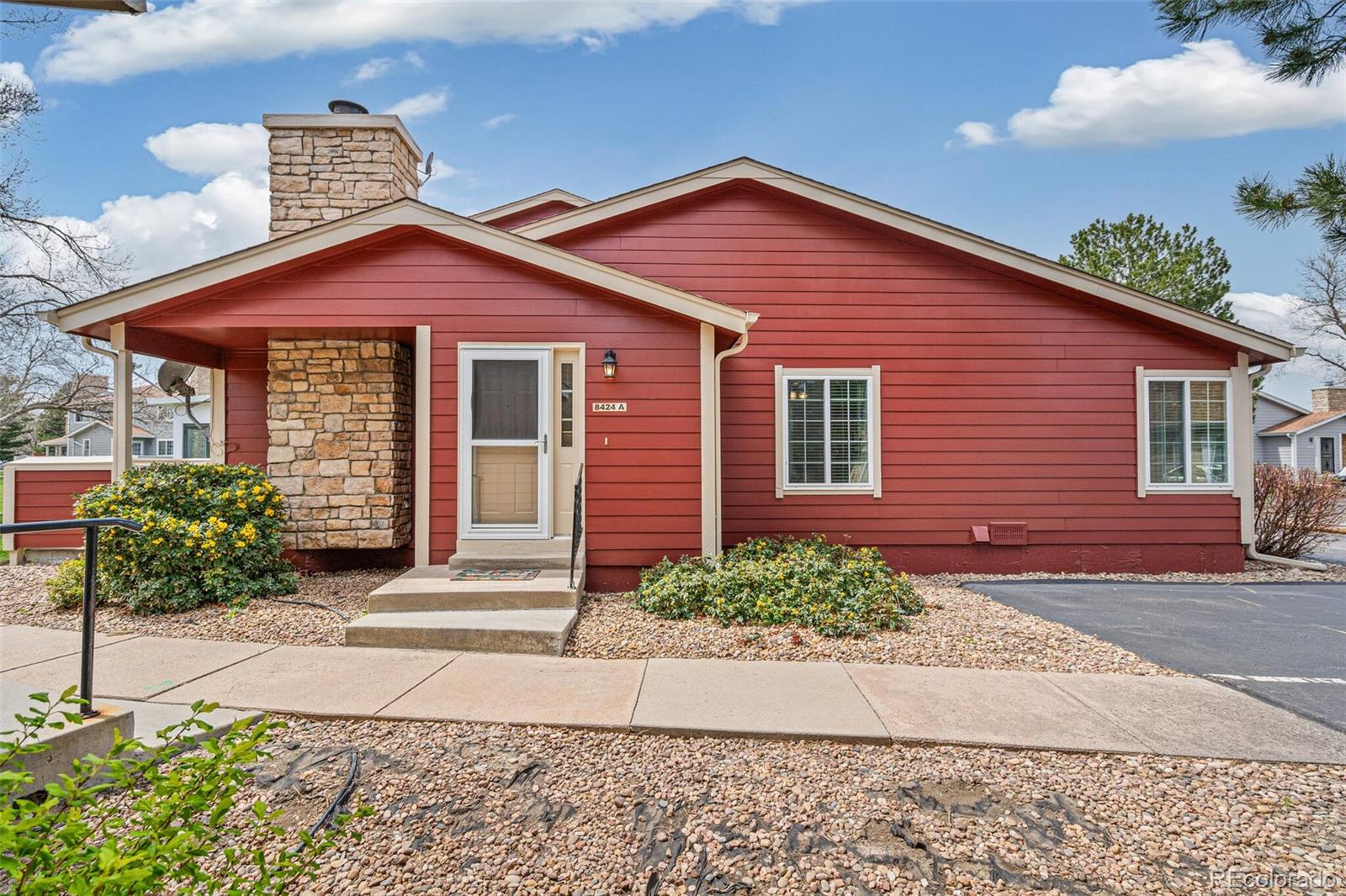 8424 Everett Way, Unit A Arvada, CO 80005 - Photo 4 of 25 a front view of a house with garden