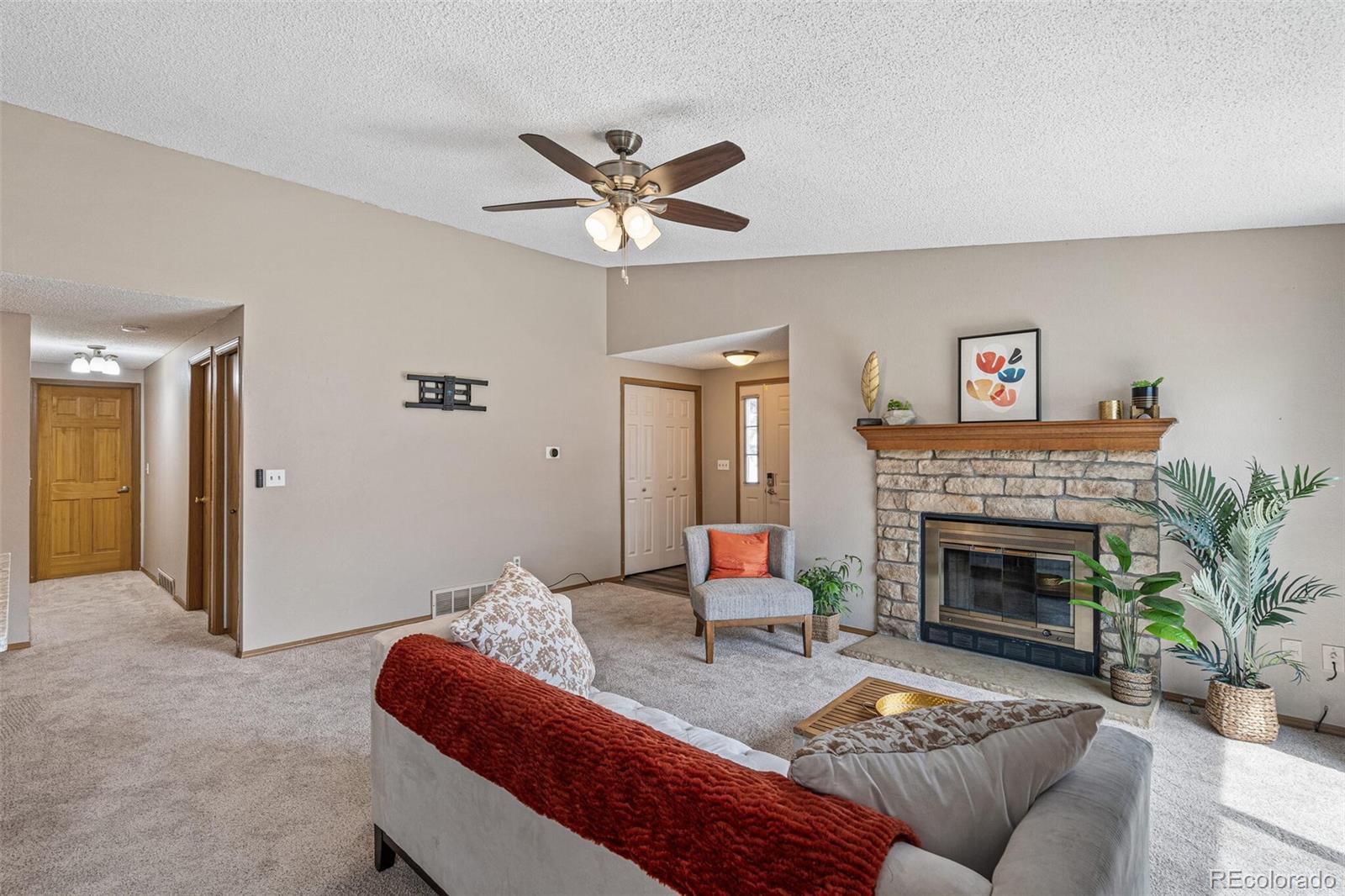 8424 Everett Way, Unit A Arvada, CO 80005 - Photo 5 of 25 a living room with furniture and a fireplace
