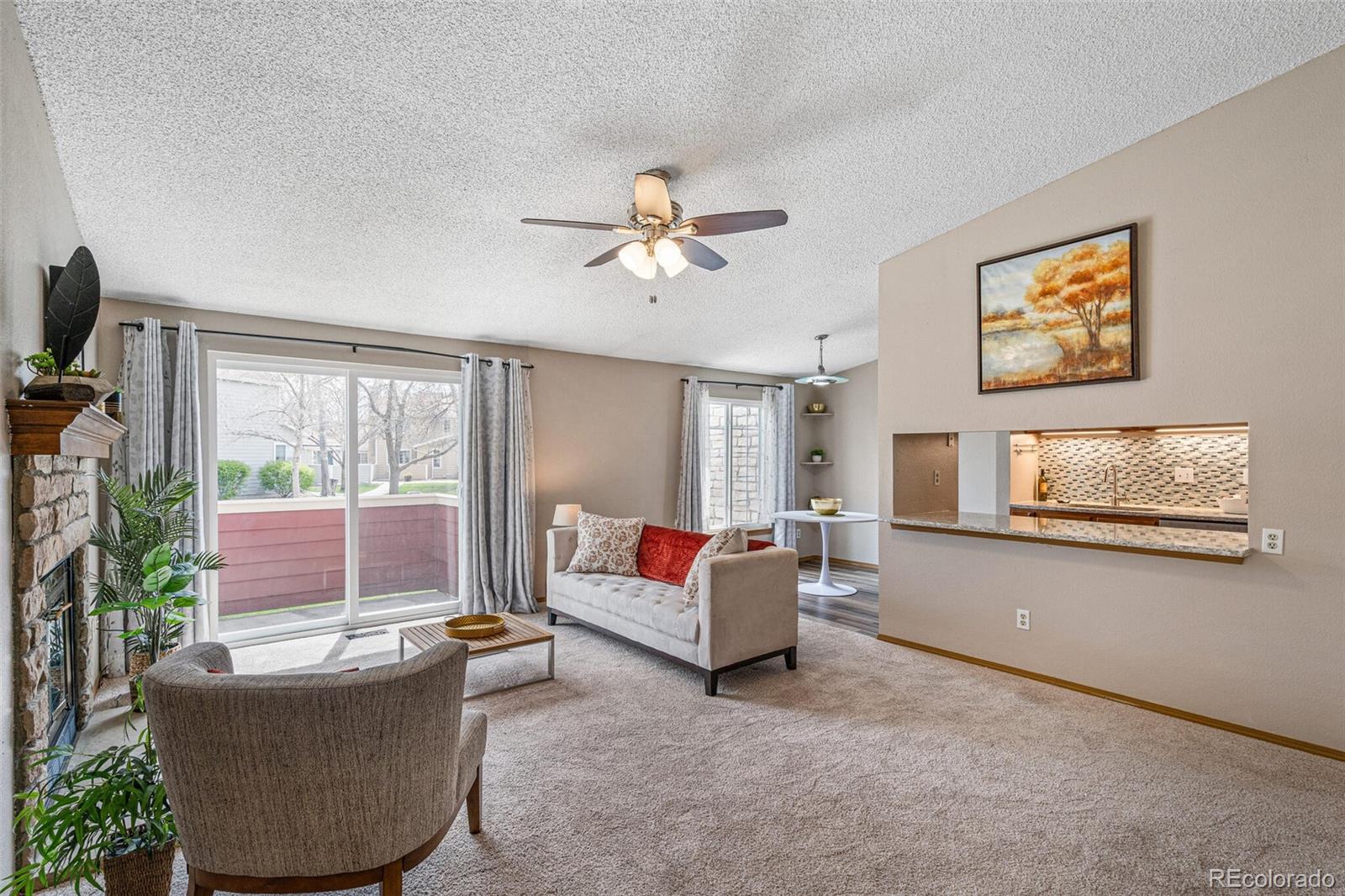 8424 Everett Way, Unit A Arvada, CO 80005 - Photo 6 of 25 a living room with furniture and a flat screen tv