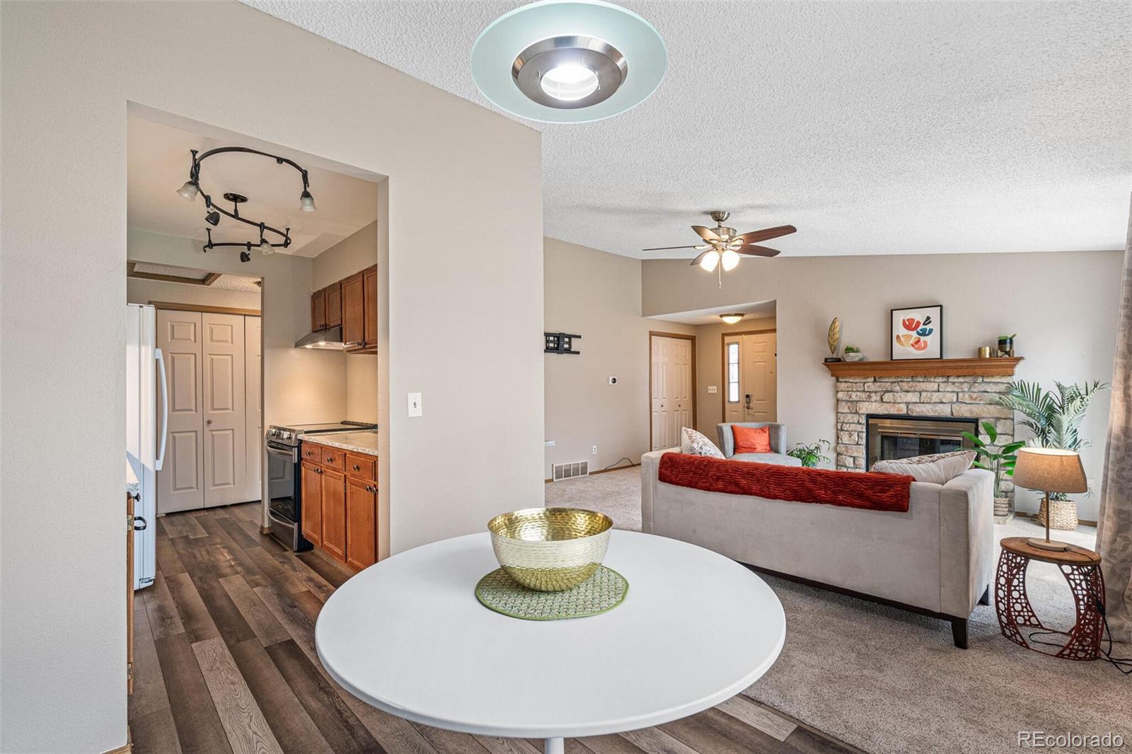 8424 Everett Way, Unit A Arvada, CO 80005 - Photo 7 of 25 a living room with furniture and a fireplace